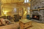 Living area with wood burning stacked stone fireplace